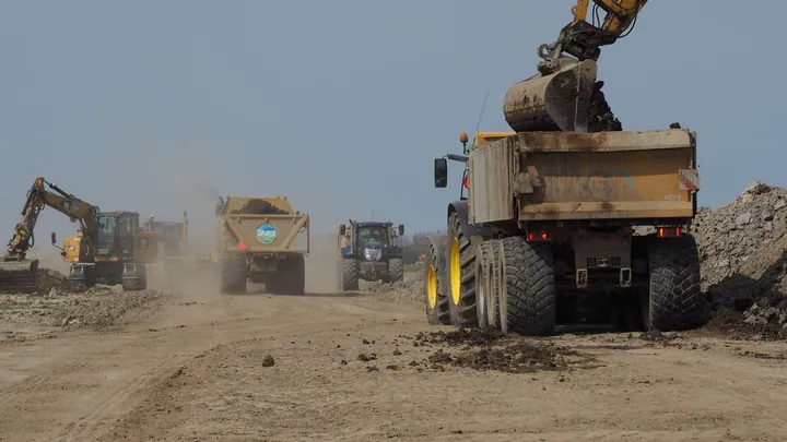 Earthmoving vehicles working across a construction site