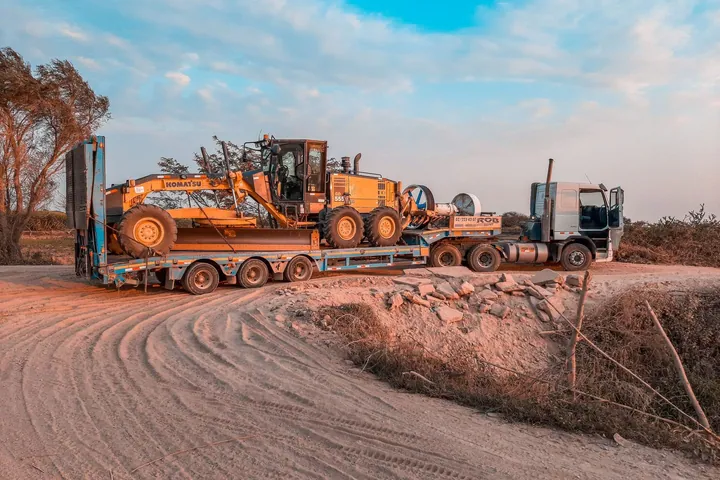 Truck carrying construction machinery on a trailer